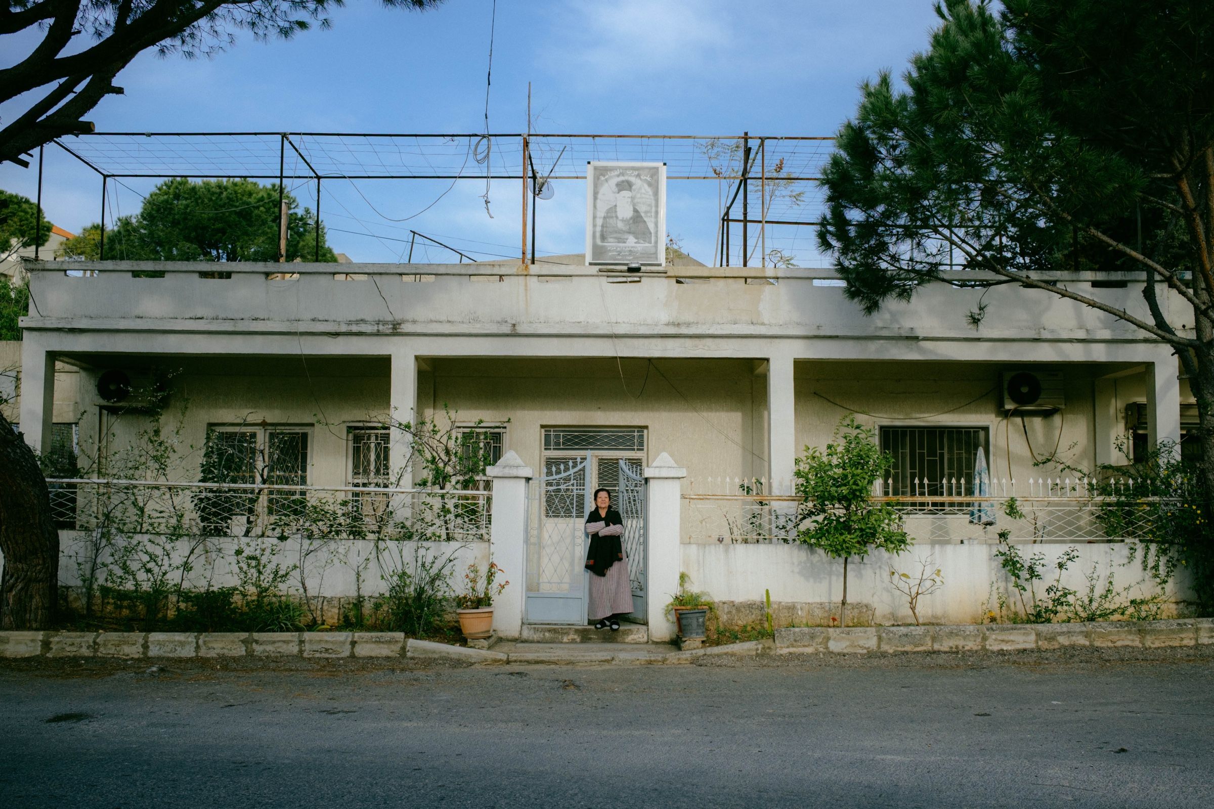 A portrait of an elderly woman in front of her home in the town of Joun, Lebanon.